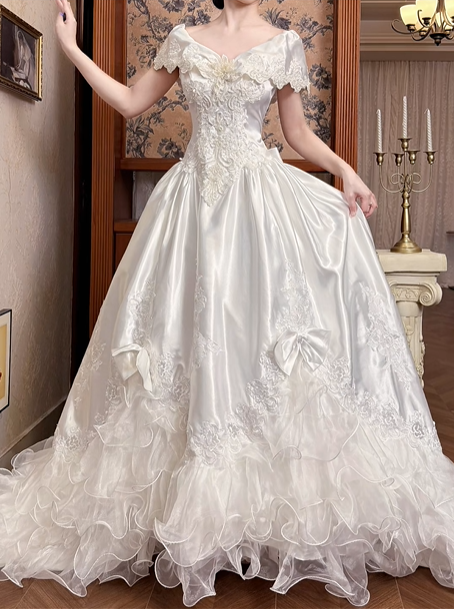 White Vintage Satin Wedding Ball Gown, V‑Neck Off‑The‑Shoulder Ruffle Cape Short Sleeves, 3D Flower Lace Appliqué Bodice, Bow Decor, Multi‑Layer Ruffle Tulle Long Train, Prom Dress gh8641