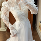 Ivory Vintage Lace Wedding Gown, Cut‑out High Neck With Keyhole V‑Detail, Puff Lace Long Sleeves With Tiered Ruffle Cuffs, Floral Lace Appliqué Waistband, A‑Line Multi‑Tier Ruffle Lace Long Train, Prom Dress gh8650
