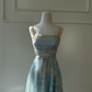 Light Lake Blue Spaghetti Strap Vintage Gown, Square Neck Lace Trim, Glitter Cut‑Out Mixed Lace Fabric, Gold Ribbon Crisscross Tie Waist, A‑Line Midi Full Skirt, Party Prom Dress gh8919